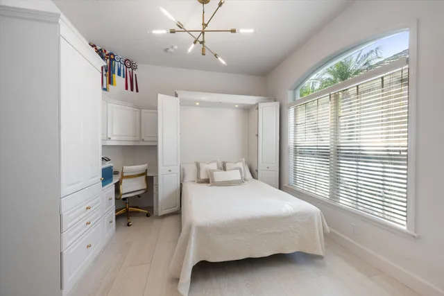 a bedroom with a bed and a large window