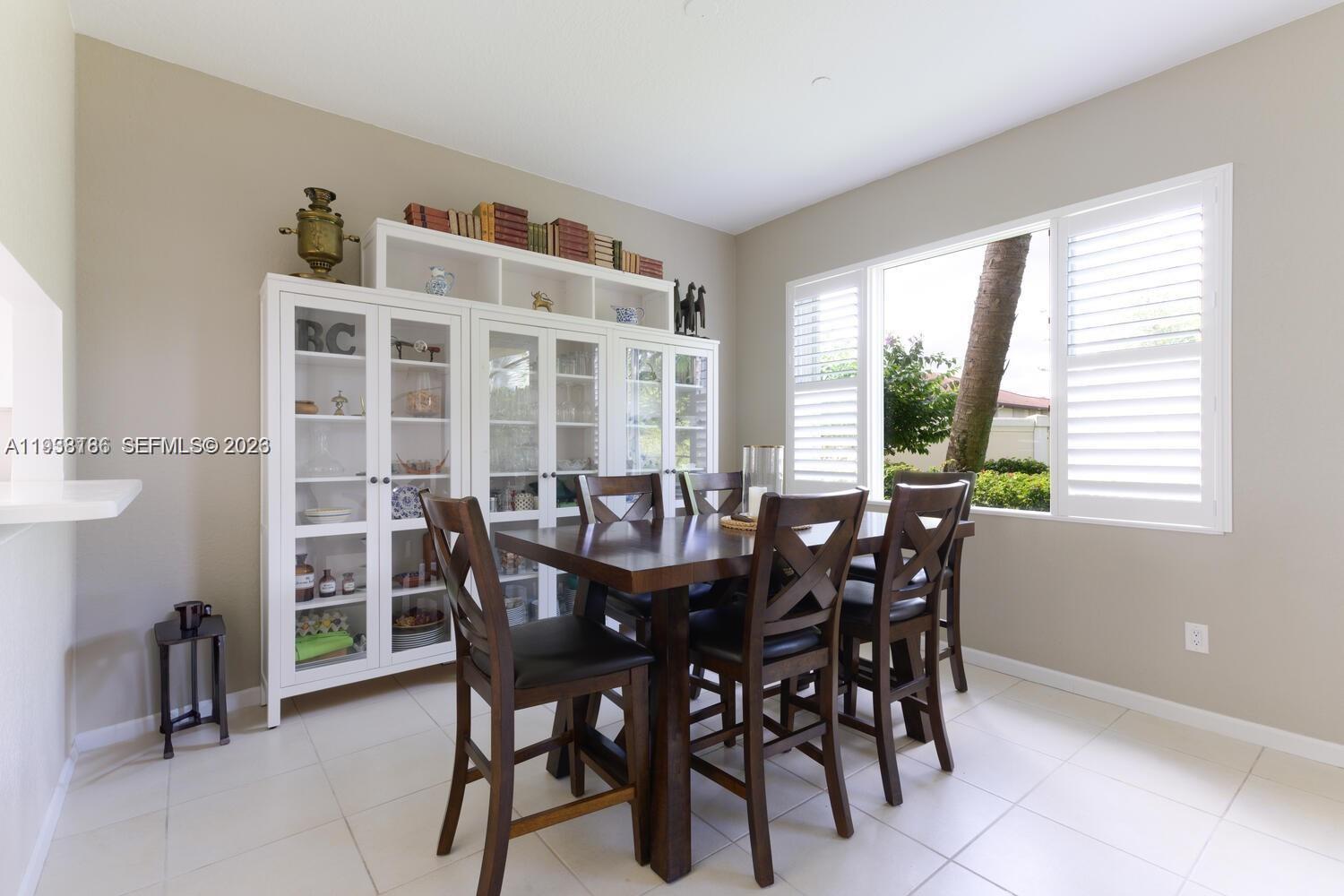 250 Southwest Walking Path, Unit 250 Stuart, FL 34997 - Photo 12 of 29 a view of a dining room with furniture and a window