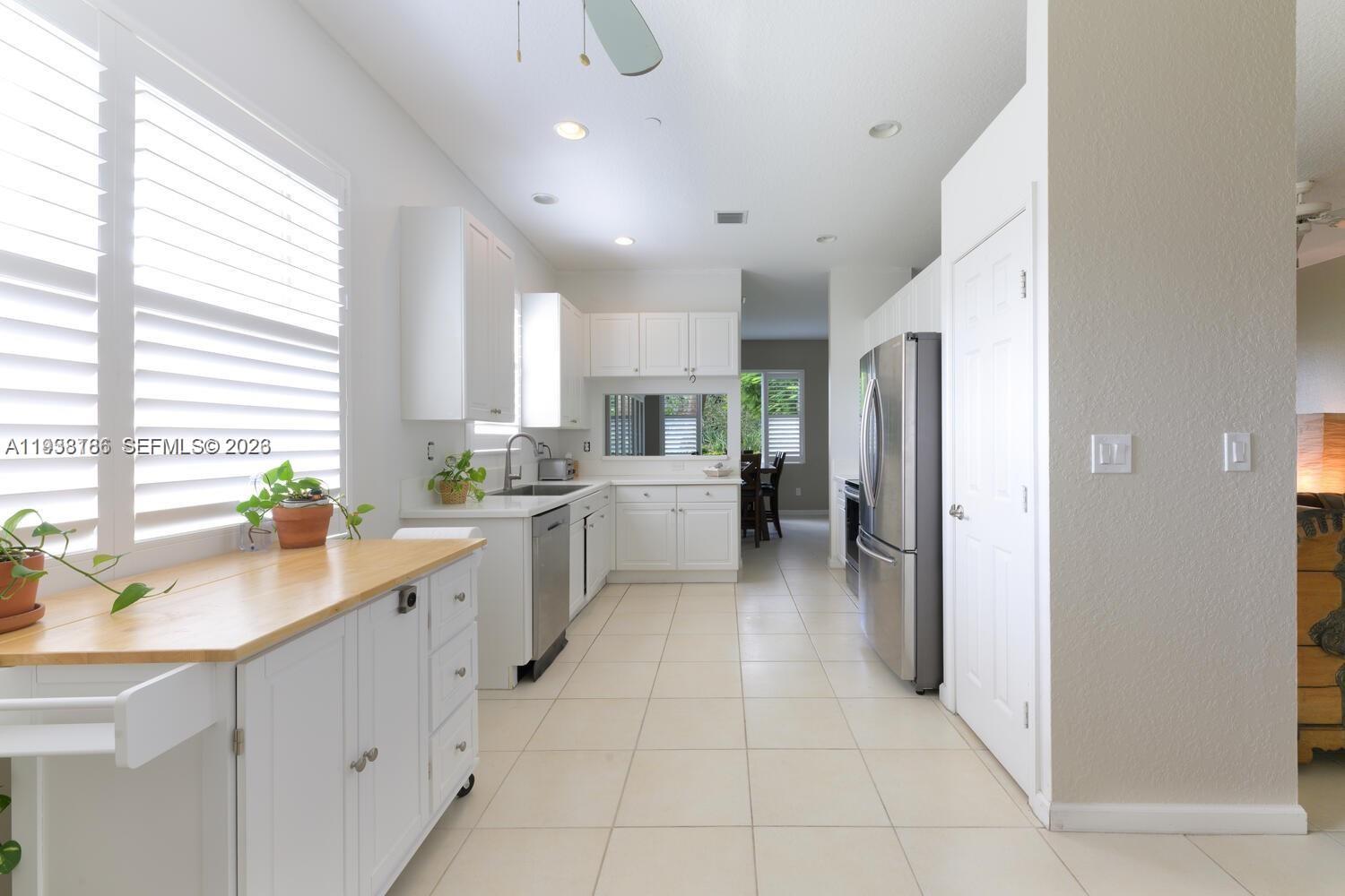 250 Southwest Walking Path, Unit 250 Stuart, FL 34997 - Photo 14 of 29 a kitchen with cabinets and window