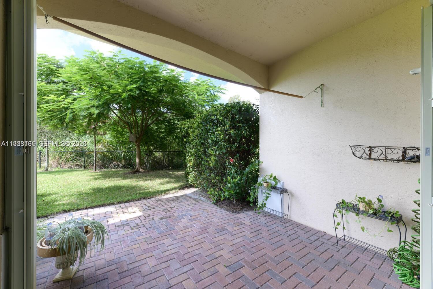 250 Southwest Walking Path, Unit 250 Stuart, FL 34997 - Photo 17 of 29 a view of a backyard with garden
