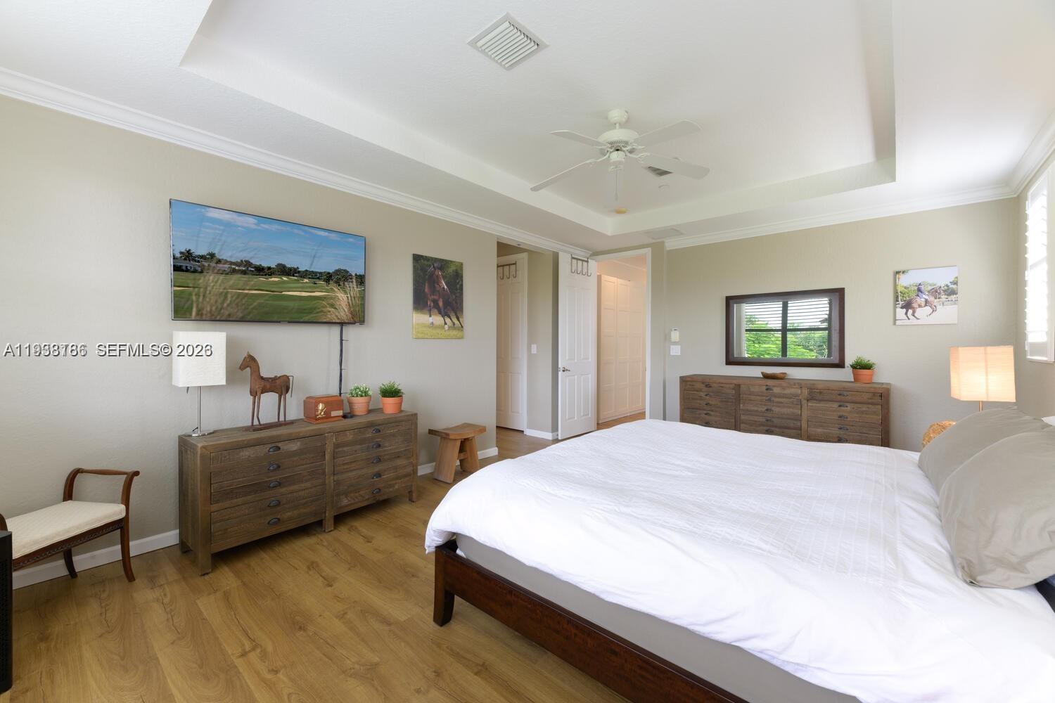 250 Southwest Walking Path, Unit 250 Stuart, FL 34997 - Photo 23 of 29 a spacious bedroom with a bed and a couch