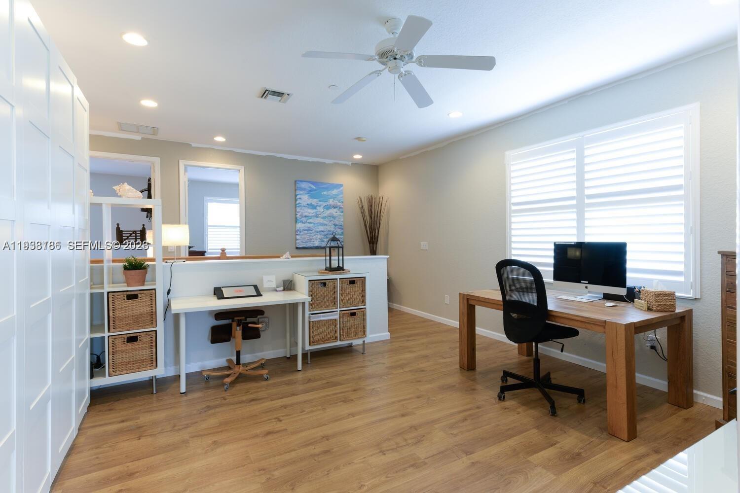 250 Southwest Walking Path, Unit 250 Stuart, FL 34997 - Photo 26 of 29 a view of a workspace with furniture and a window