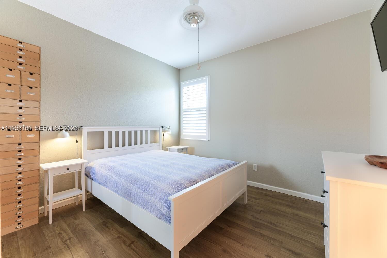 250 Southwest Walking Path, Unit 250 Stuart, FL 34997 - Photo 28 of 29 a bedroom with a bed and a table