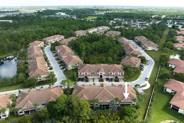 an aerial view of multiple houses with yard