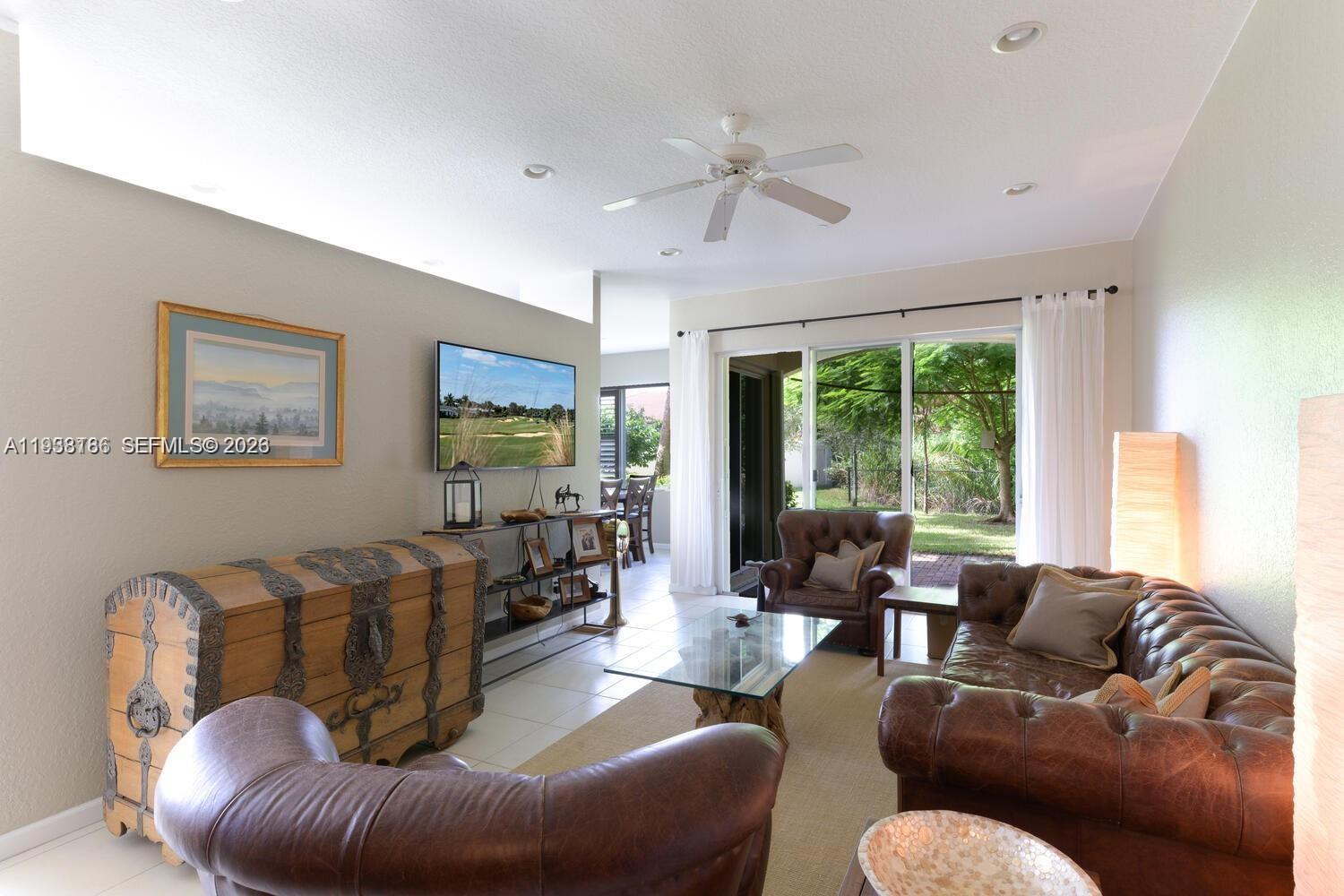 250 Southwest Walking Path, Unit 250 Stuart, FL 34997 - Photo 10 of 29 a living room with furniture or couch and a large window