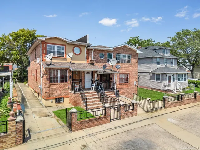 a front view of a building with outdoor seating