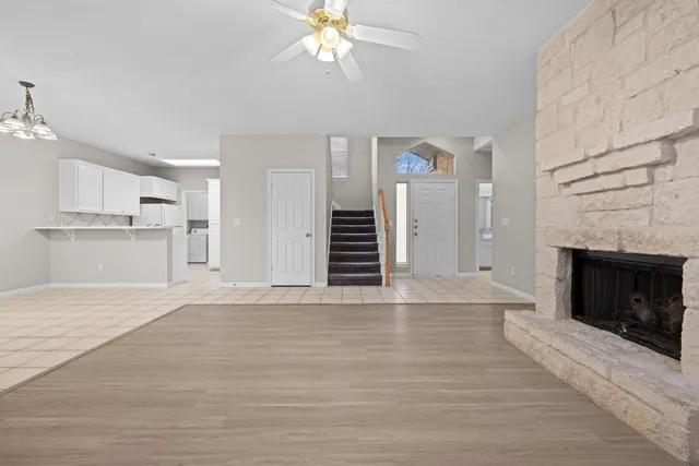 a view of a kitchen with an empty space and a fireplace