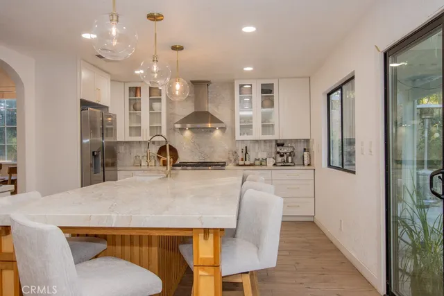 a kitchen with kitchen island a appliances dining table and chairs
