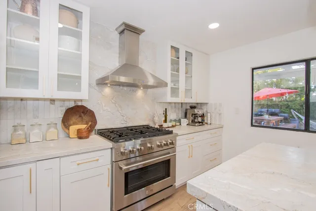 a kitchen with stainless steel appliances granite countertop a stove and a sink