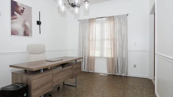 a view of a room with furniture and window