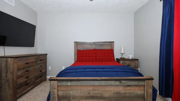 a bedroom with a bed and a chandelier
