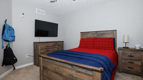 a bedroom with a bed and a dresser