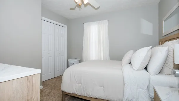 a bedroom with a bed and a window