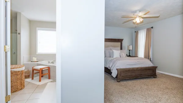 a bedroom with a bed and a chandelier