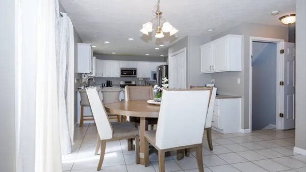a view of a dining room with furniture and a window