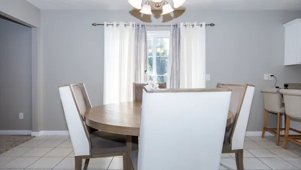 a view of a dining room with furniture and chandelier