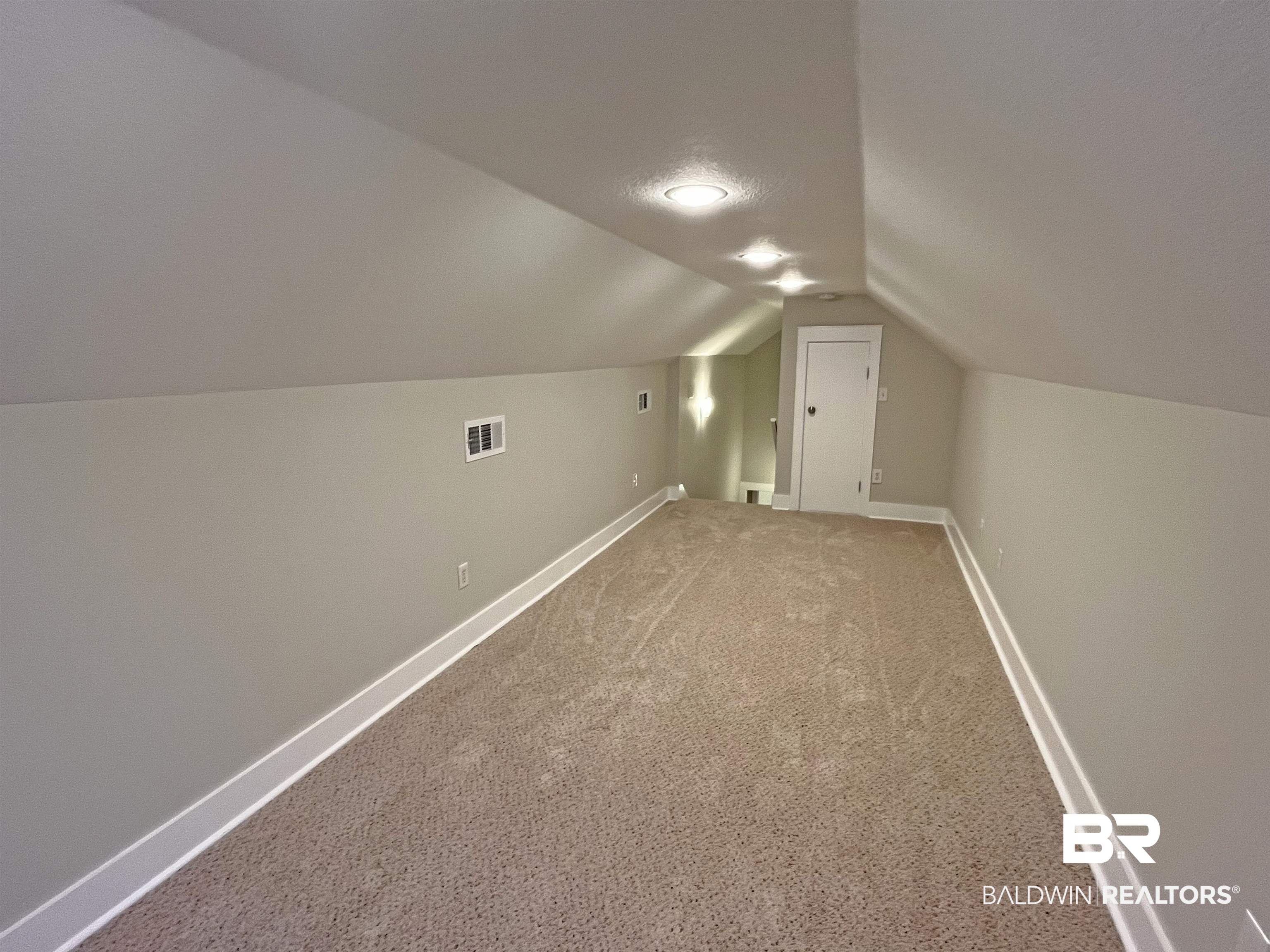 22023 Garland Loop Silverhill, AL 36576 - Photo 26 of 33 Bonus room with lofted ceiling and carpet