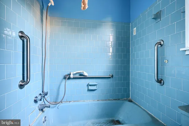 a view of backyard of house with wooden fence