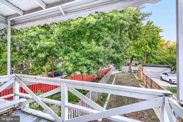 a balcony with view of trees in the background