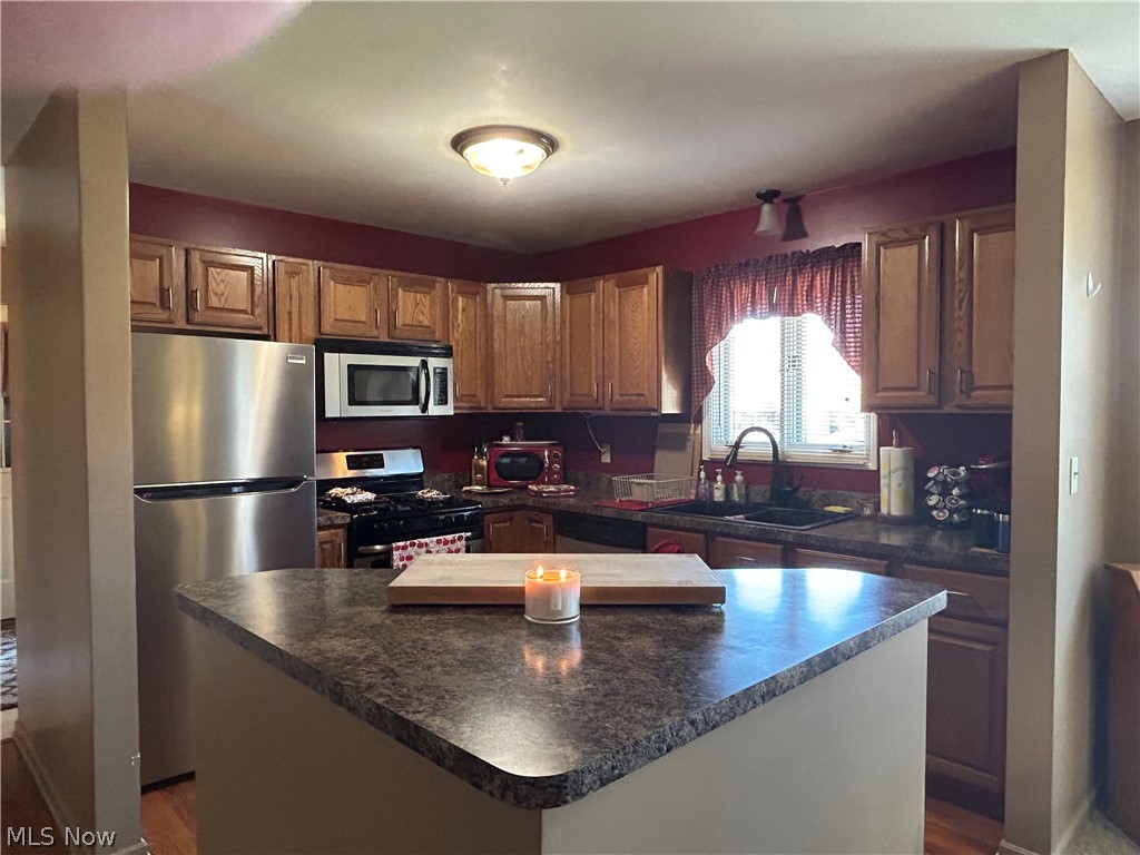 40 East Western Reserve Road, Unit 1 Youngstown, OH 44514 - Photo 6 of 33 Kitchen with a kitchen island, appliances with stainless steel finishes, wood-type flooring, and sink