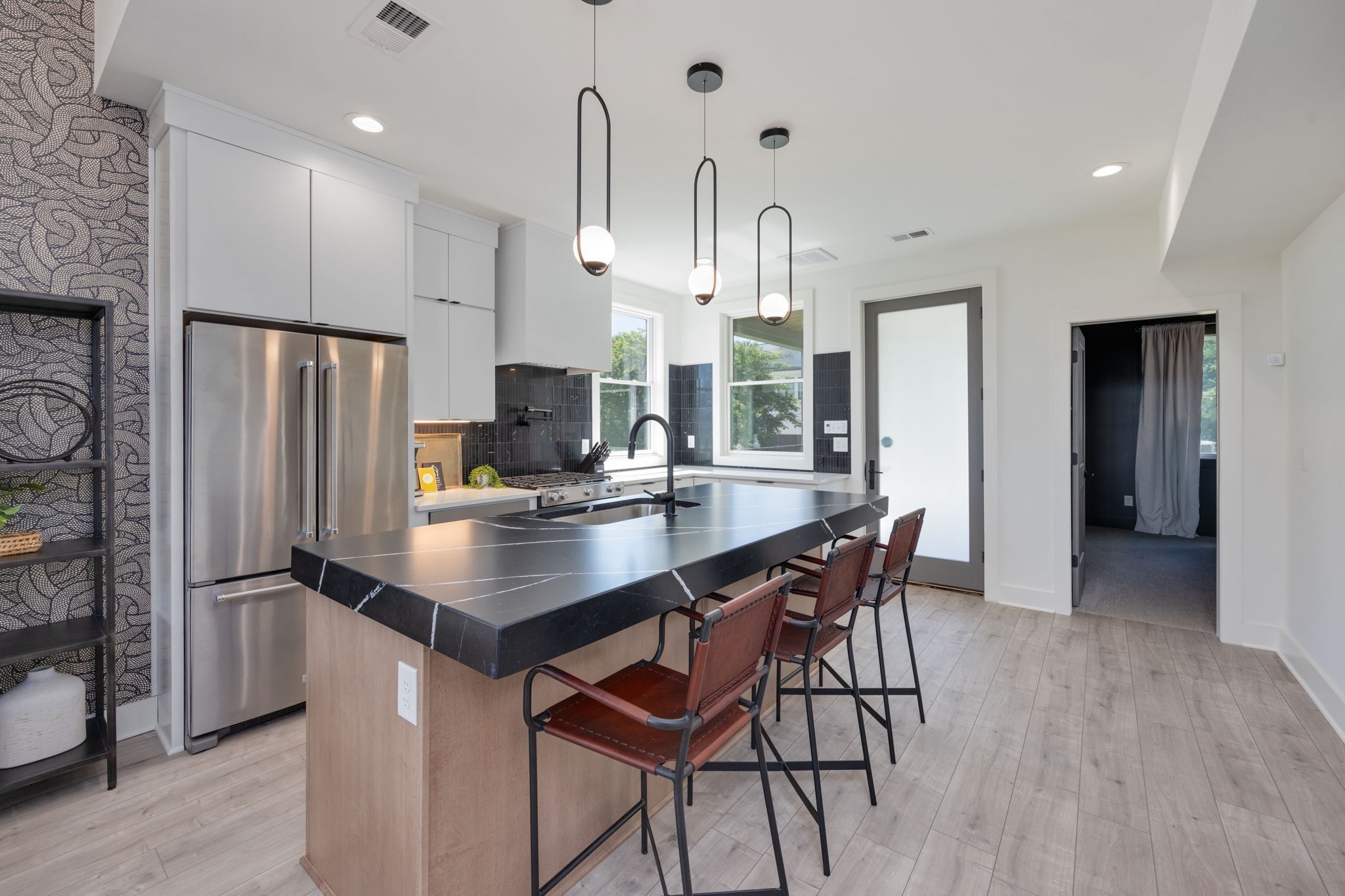 1007 Summit Avenue Nashville, TN 37203 - Photo 12 of 45 a kitchen with stainless steel appliances a dining table chairs refrigerator and cabinets
