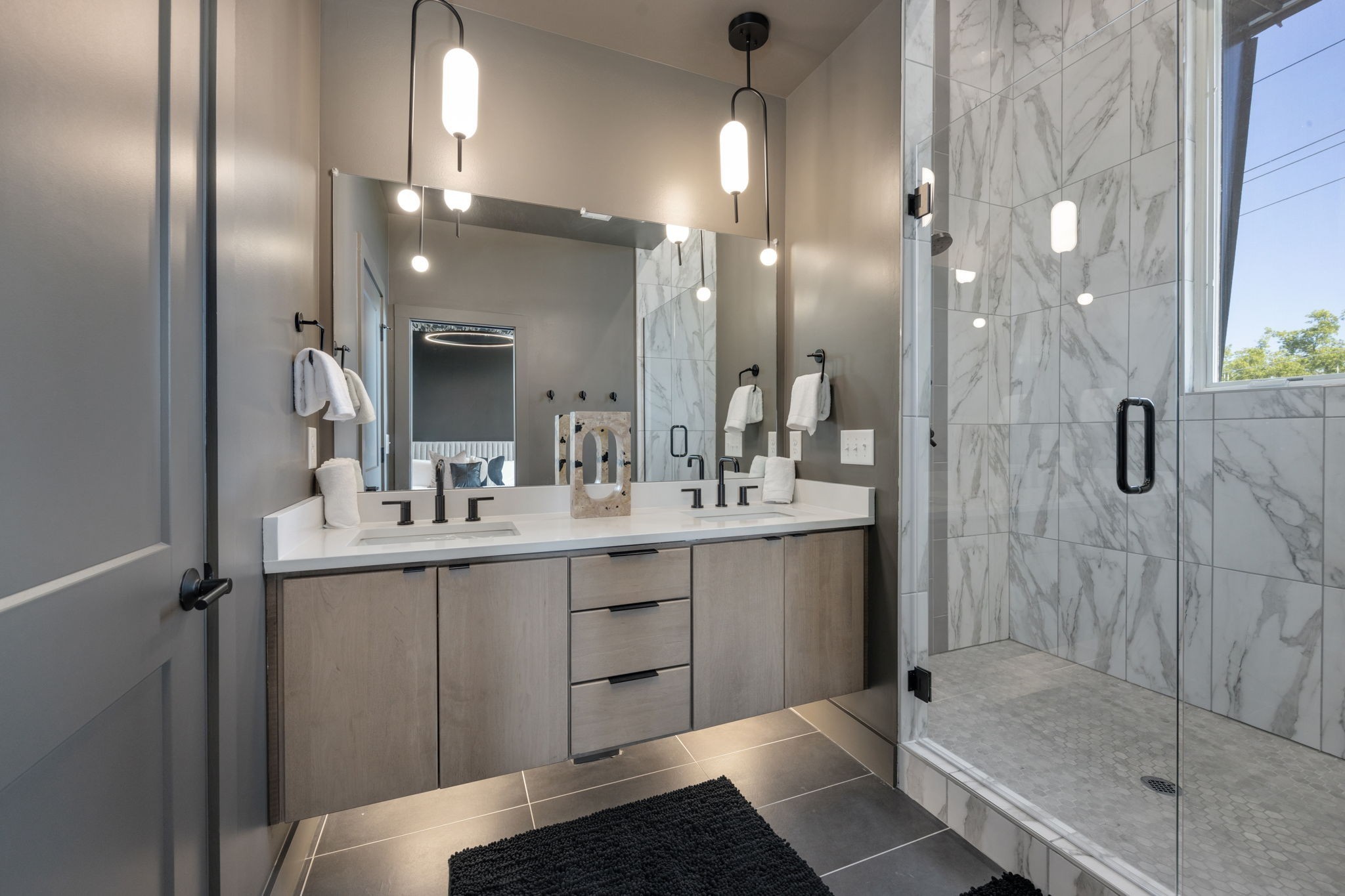 1007 Summit Avenue Nashville, TN 37203 - Photo 19 of 45 a bathroom with a double vanity sink mirror and shower