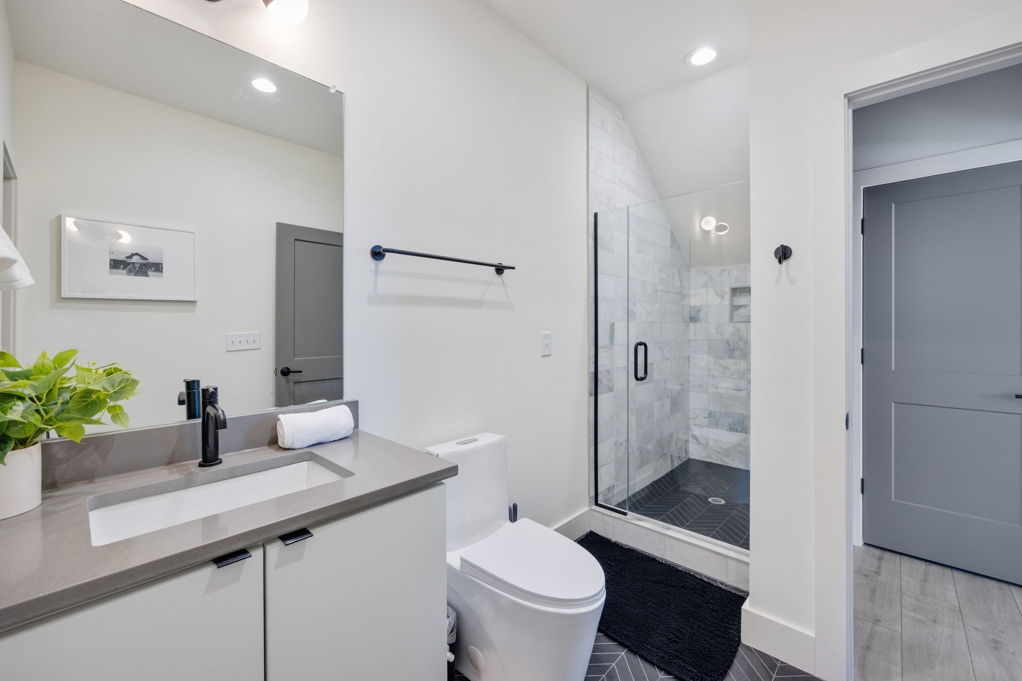 1007 Summit Avenue Nashville, TN 37203 - Photo 39 of 45 a bathroom with a sink a toilet a large mirror and shower