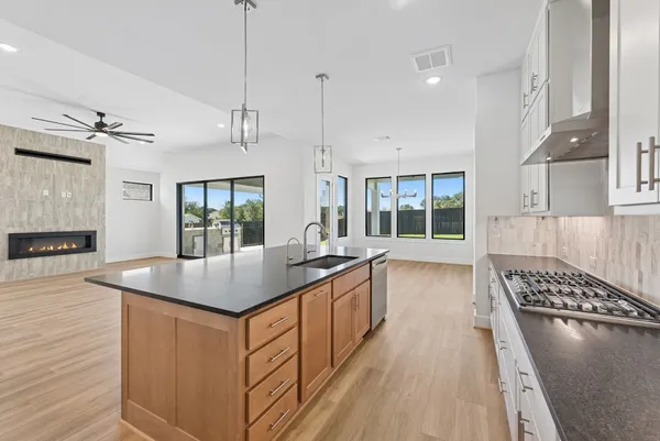 a kitchen with sink stove and window