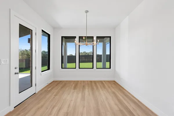 a view of an empty room with glass door