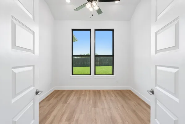 wooden floor in an empty room with a window