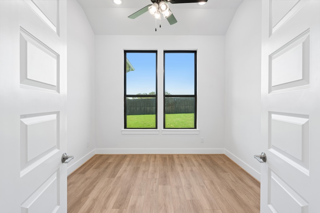 3408 Emerald Lake Path Georgetown, TX 78628 - Photo 17 of 38 wooden floor in an empty room with a window
