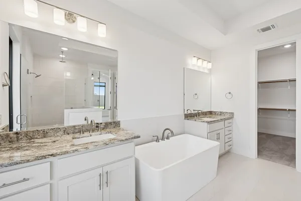 a bathroom with a sink double vanity and a mirror