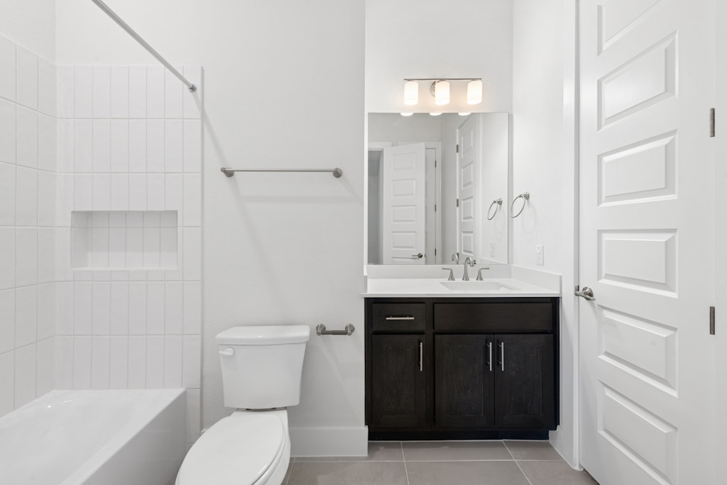 3408 Emerald Lake Path Georgetown, TX 78628 - Photo 32 of 38 a bathroom with a sink a toilet and shower