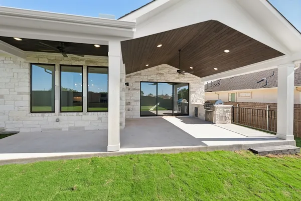 a view of a house with backyard porch and sitting area