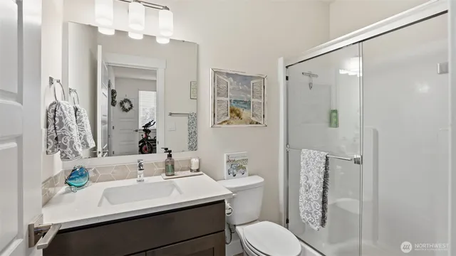 a bathroom with a sink toilet and mirror