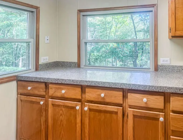 a kitchen with a window and cabinets