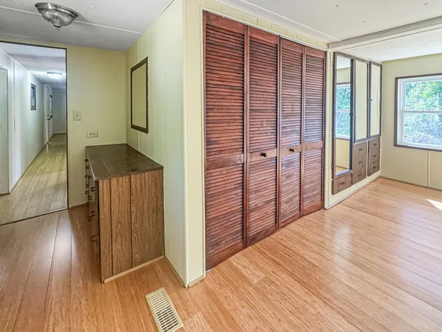 a view of hallway with wooden floor
