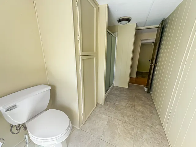 a white toilet sitting next to a bathroom sink