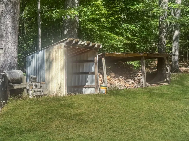 a view of a chair and table in backyard