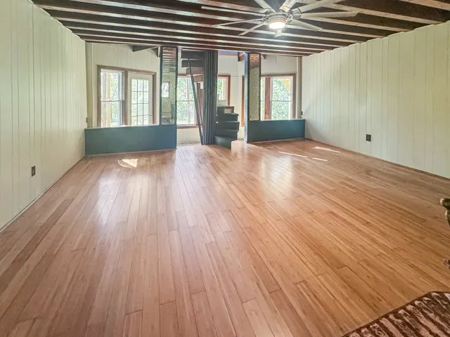 wooden floor in an empty room with a window