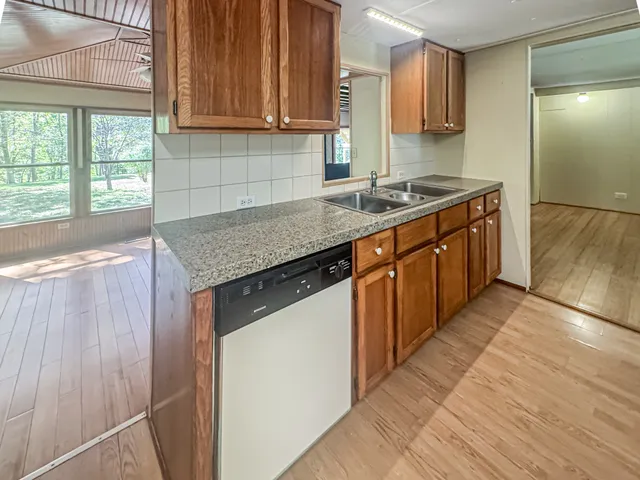 a kitchen with stainless steel appliances granite countertop a sink stove and cabinets