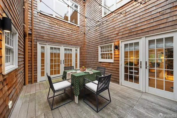 a dining hall with stainless steel appliances a table and chairs with wooden floor
