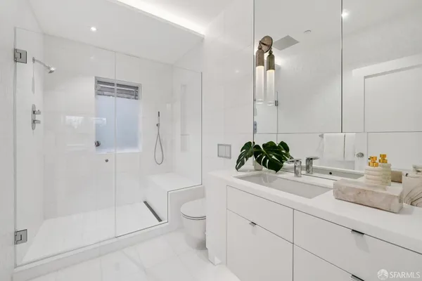 a bathroom with a tub sink and mirror