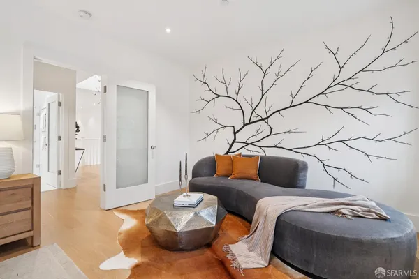 a view of a hallway to a livingroom with furniture