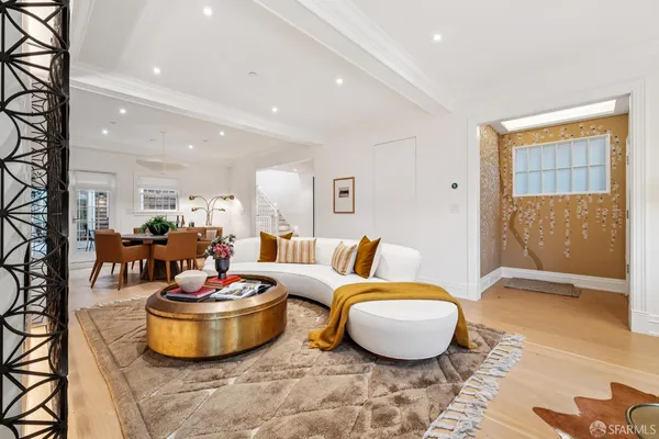 a living room with furniture and a potted plant