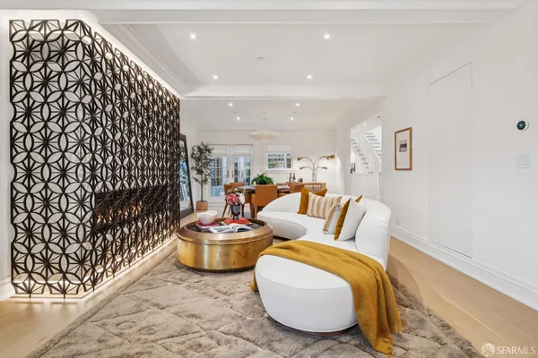 a living room with furniture and a potted plant