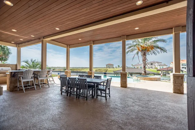 a view of a patio with dining table and chairs