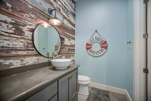 a bathroom with a toilet a sink and mirror