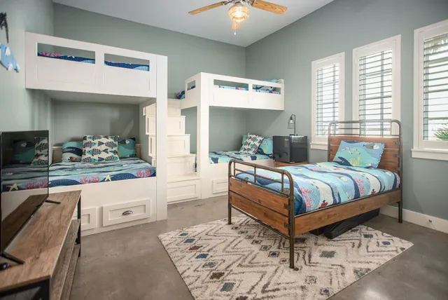 a bedroom with a large bed and a chandelier