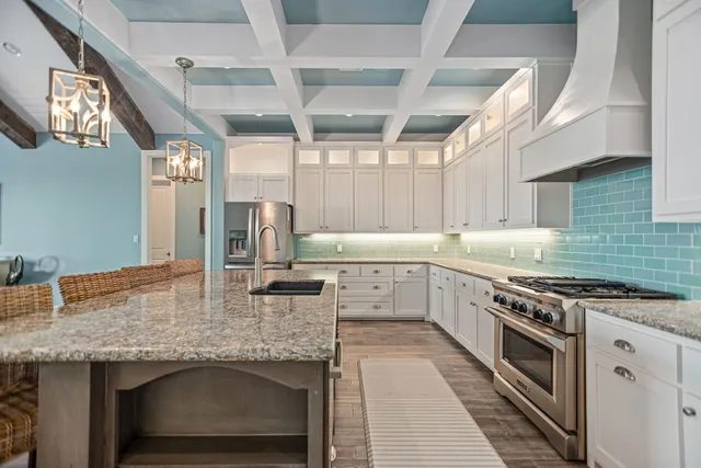 a kitchen with a table chairs refrigerator and cabinets